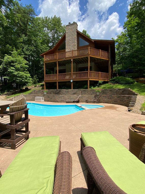A large house with a swimming pool in front of it