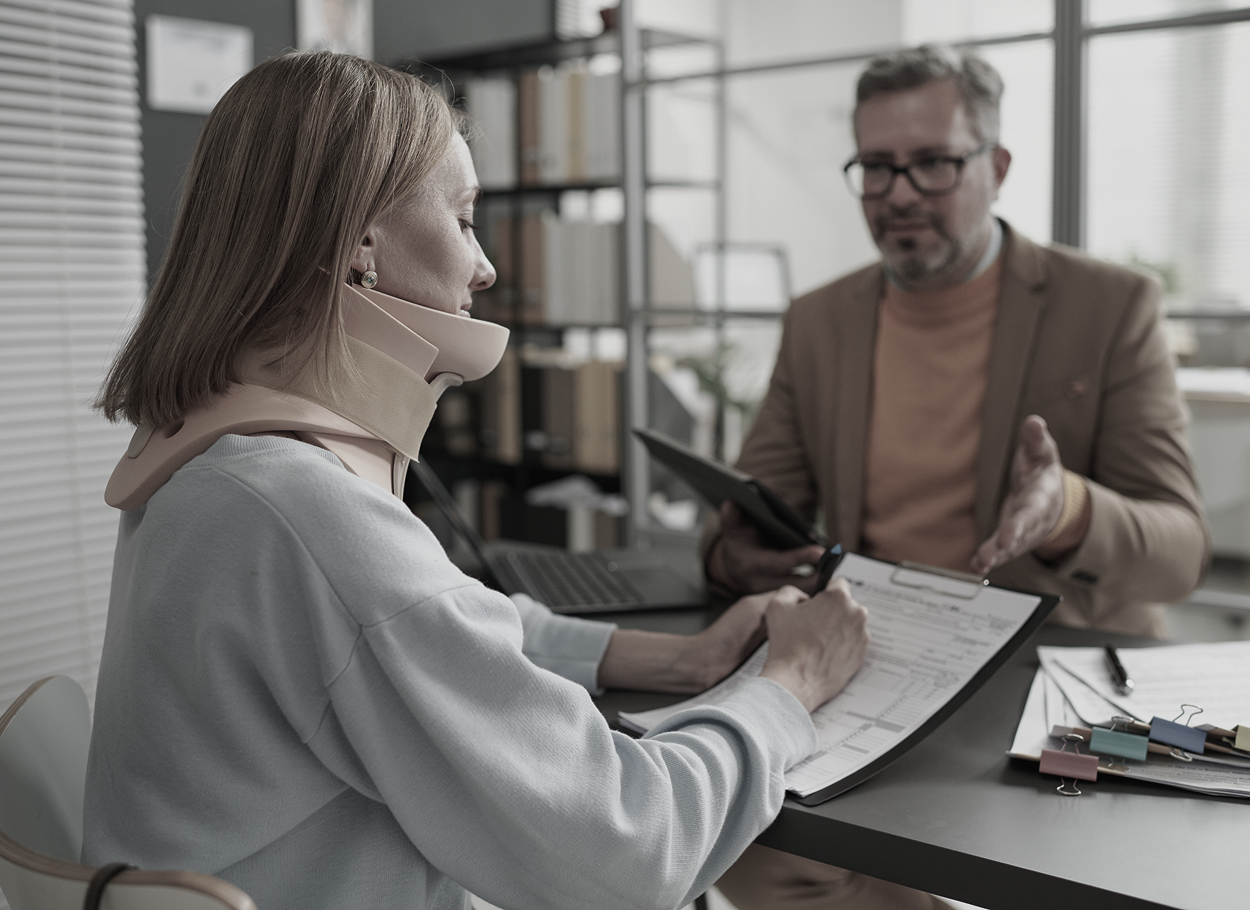 A woman with a neck brace is sitting at a table with a man.