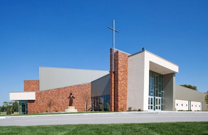A large church with a cross on top of it.