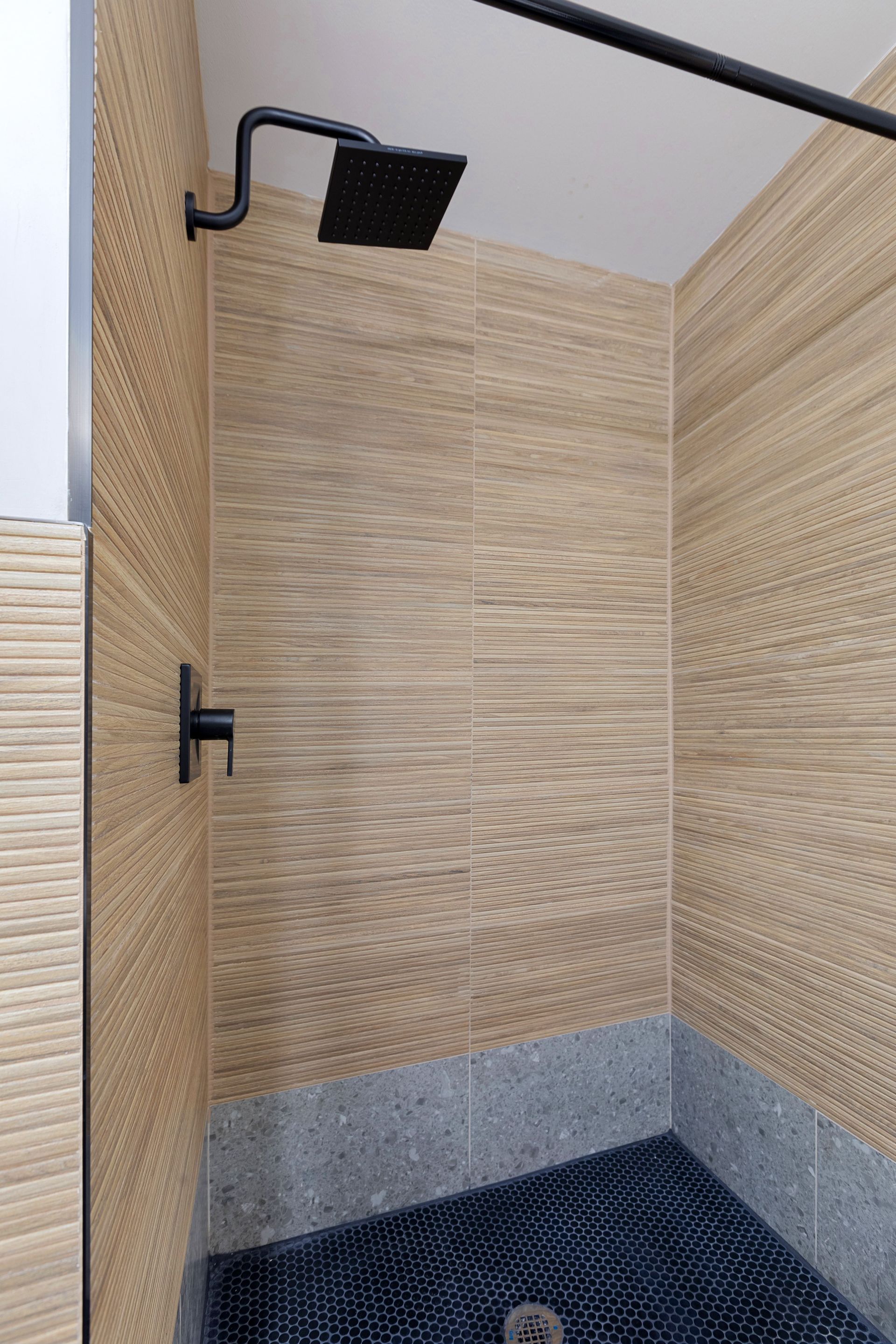 Shower with wood tile in a 2 bedroom apartment for rent in New Jersey