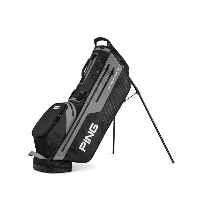 A ping golf bag is sitting on a stand on a white background.