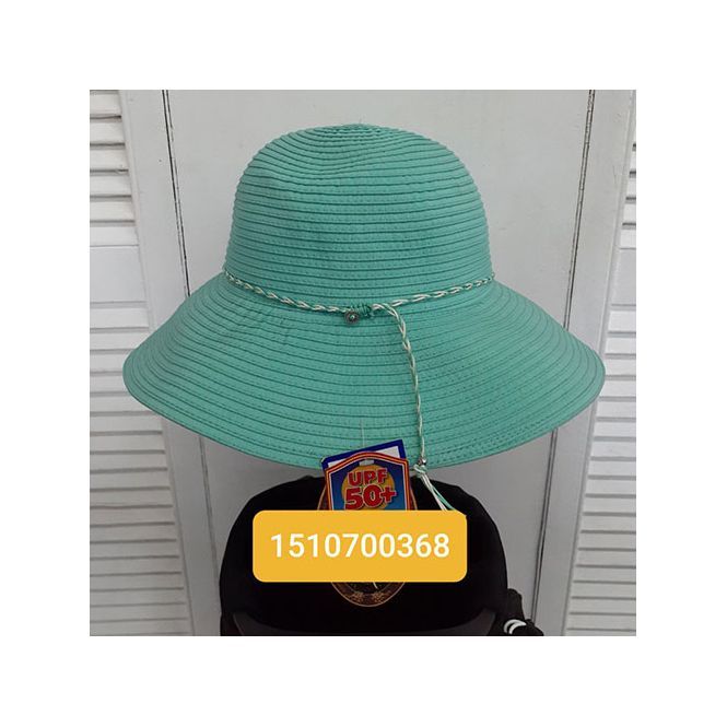 A green hat is sitting on top of a black hat.