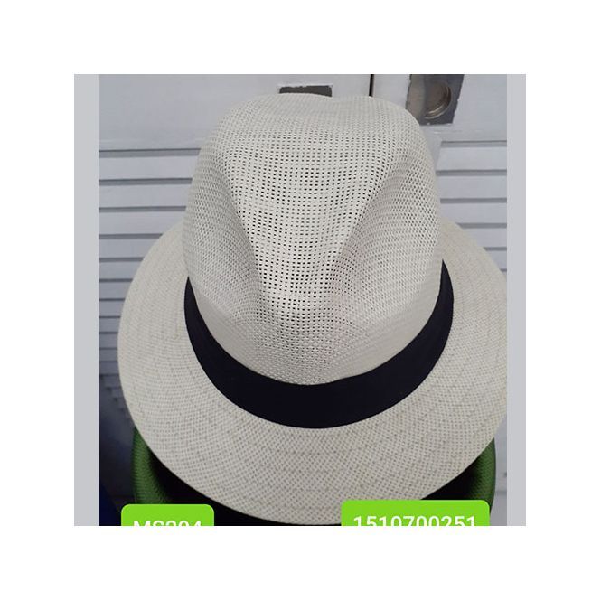 A white hat with a black band sits on a green box