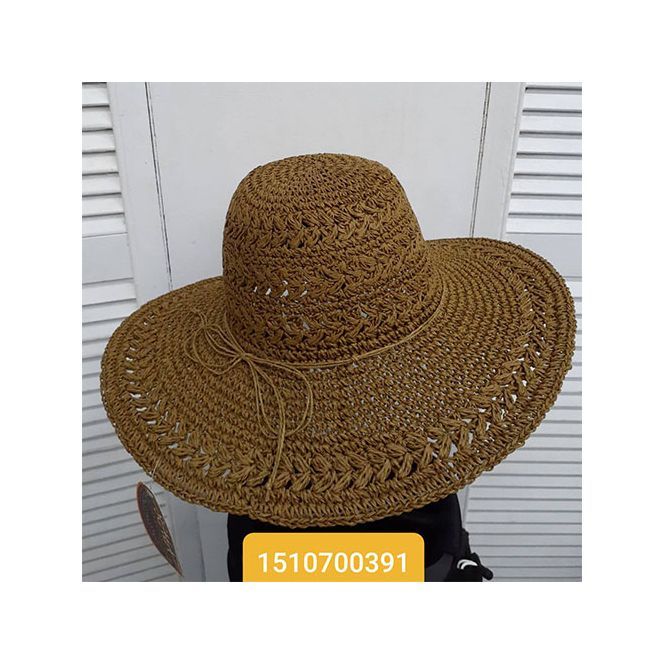 A straw hat is sitting on a table in front of a white door.