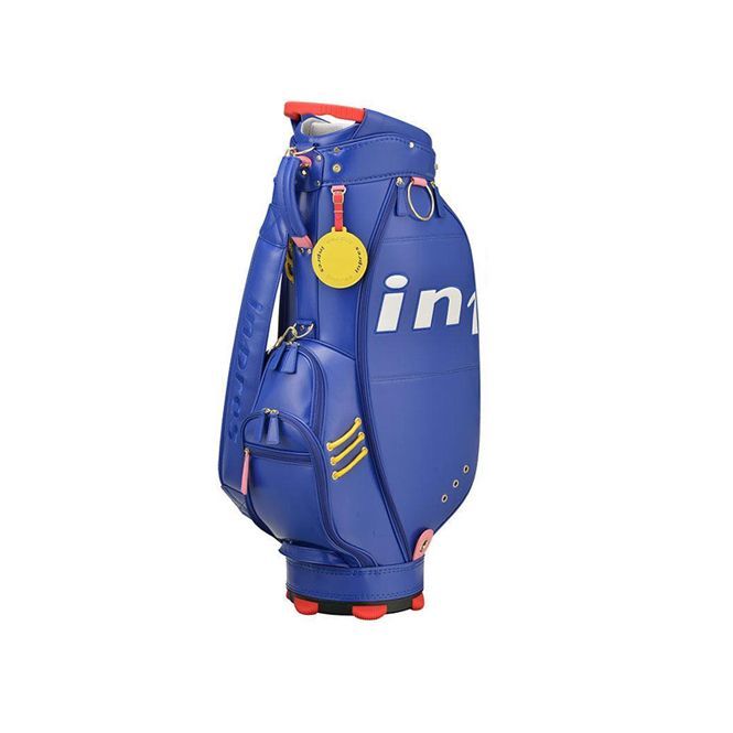 A blue golf bag with a yellow tag on it on a white background.