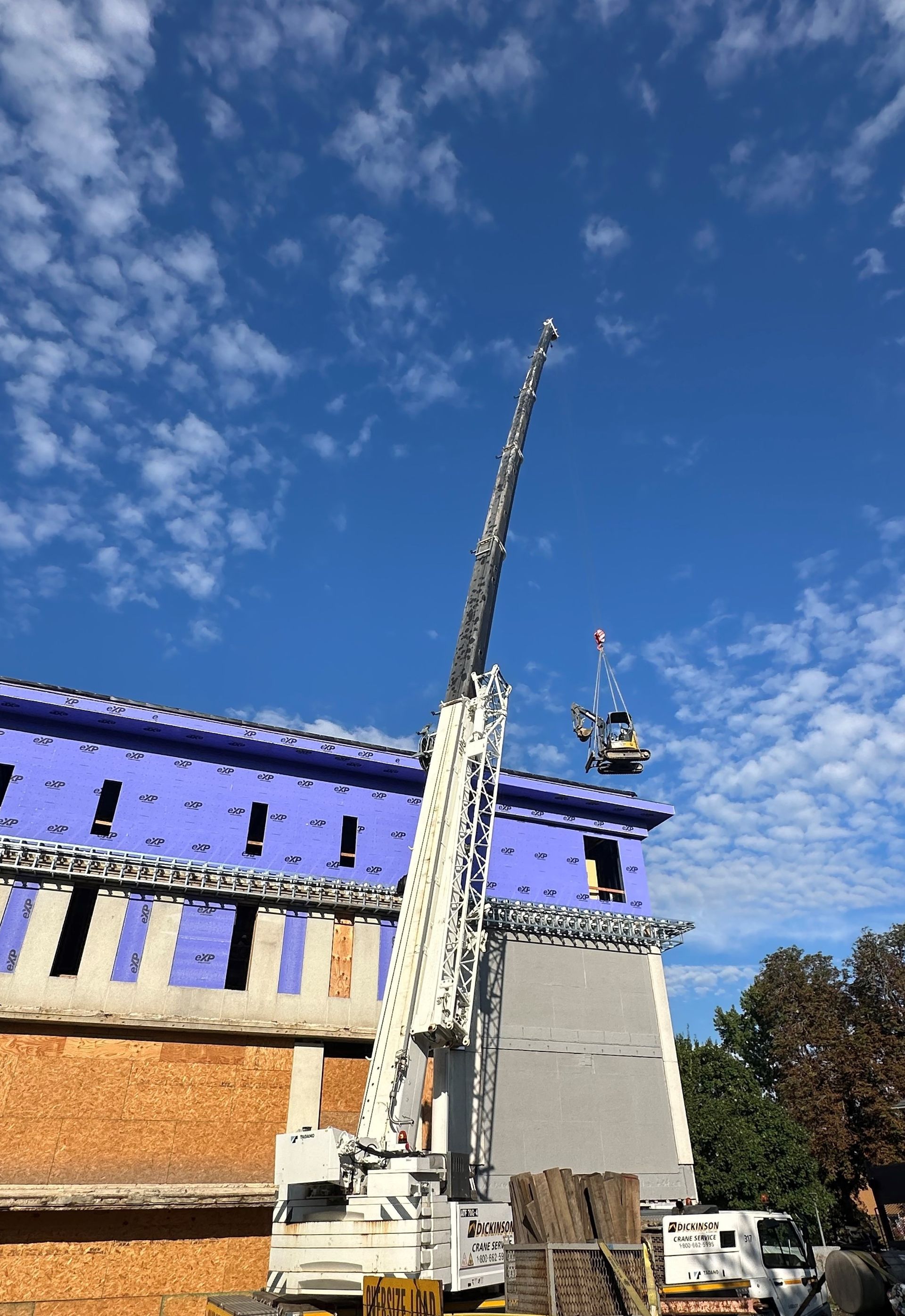 Empire Services uses a crane to deliver equipment in the building for new elevator pit.