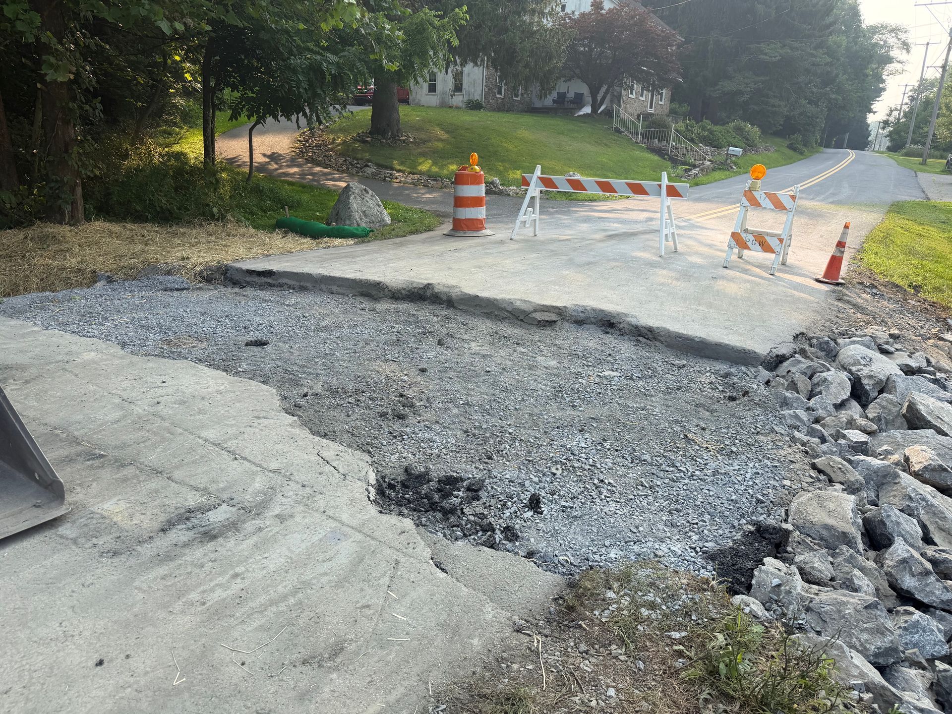 The stone material is spread out over the new culvert.