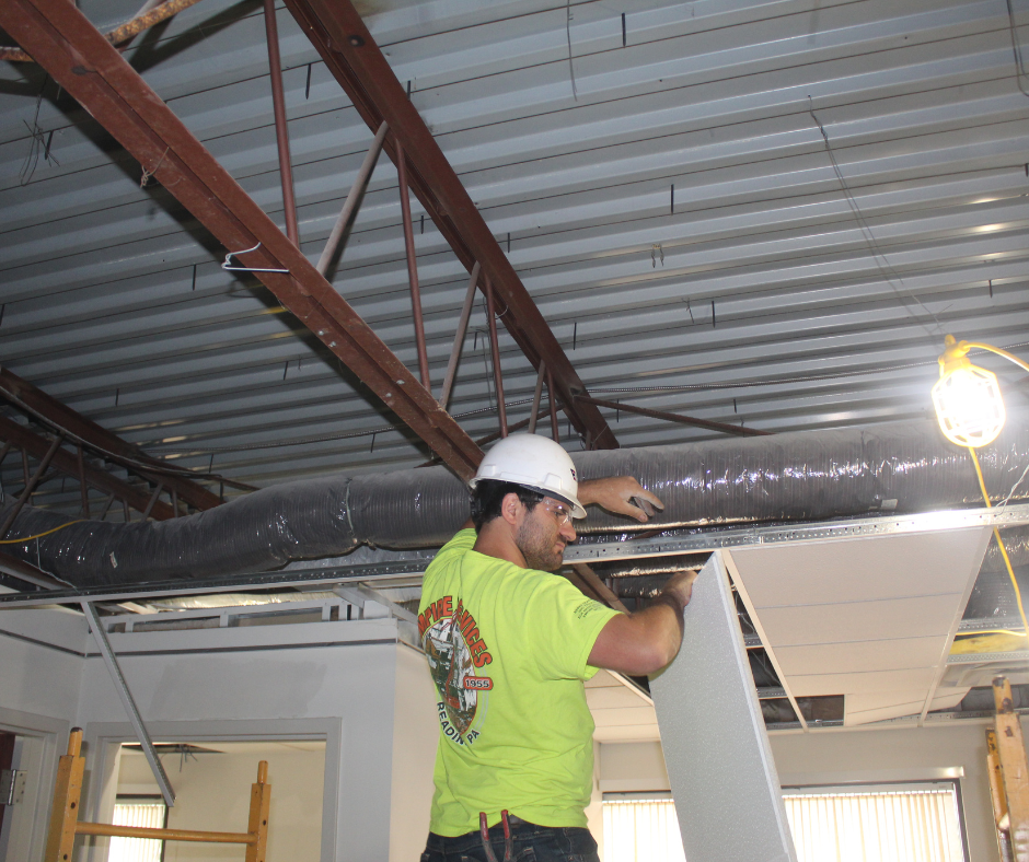 Removing ceiling tiles.