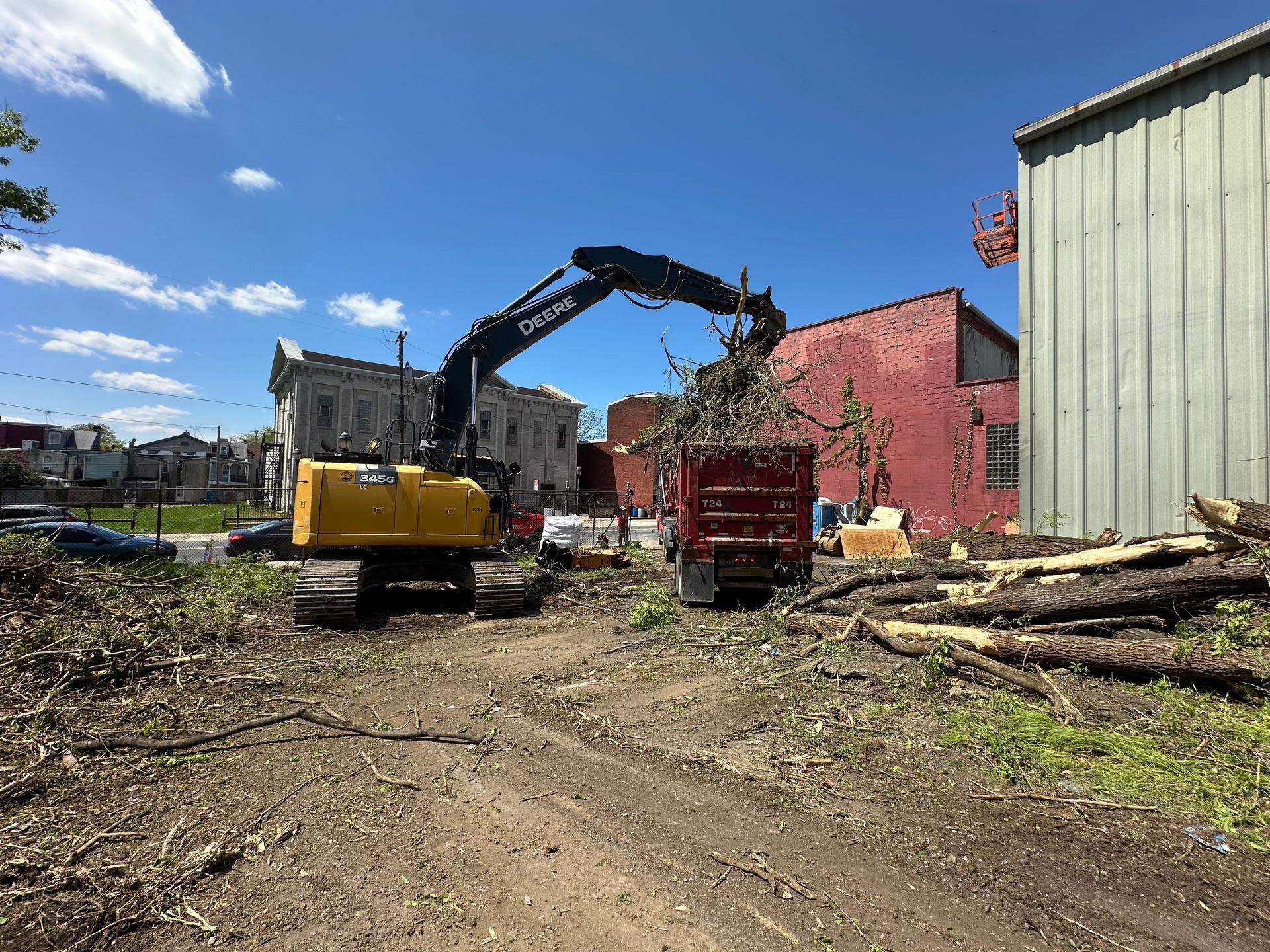 Empire Services crew loads cleared debris into a DVC truck for disposal.