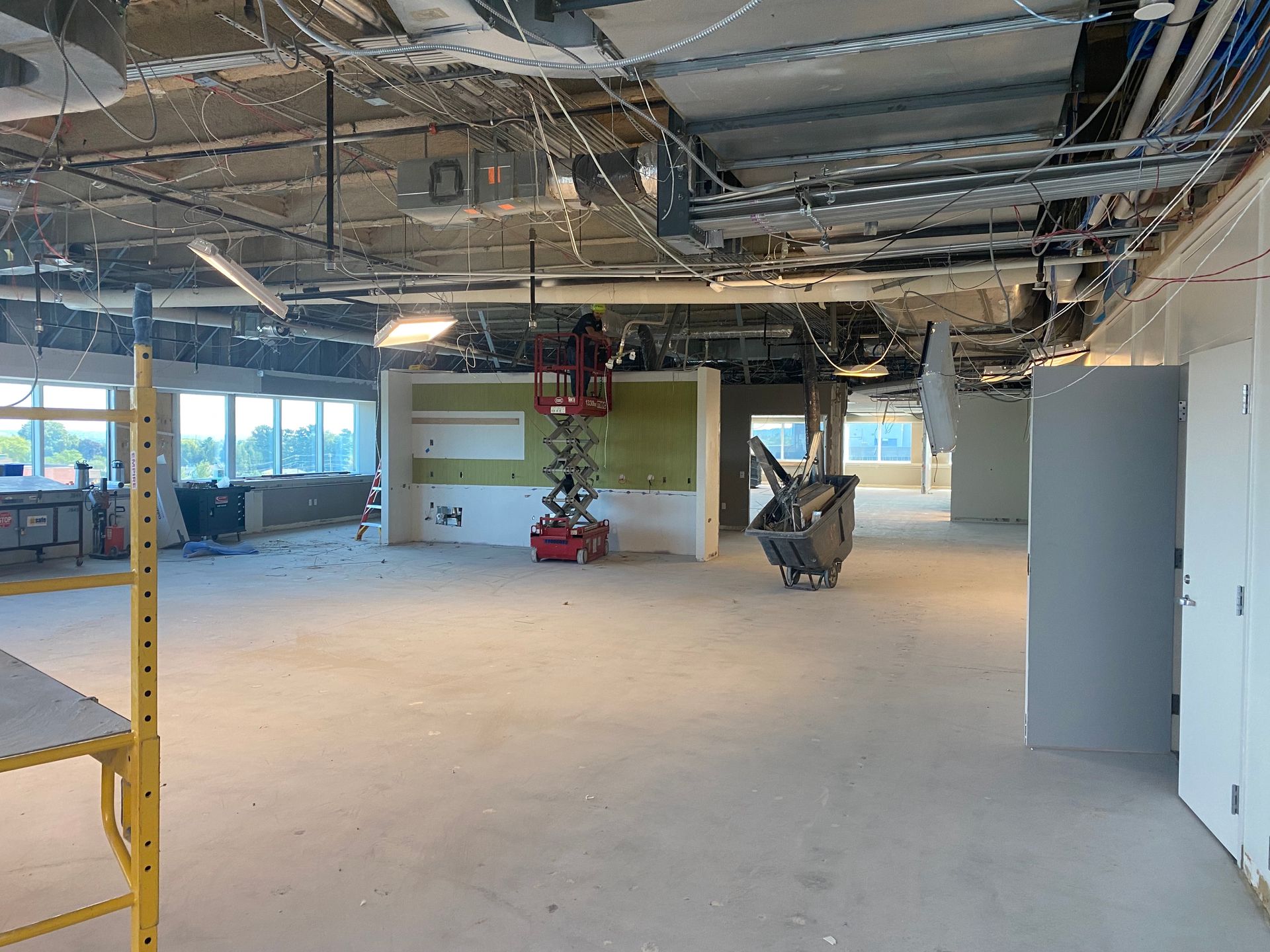 A large empty room with a lot of wires hanging from the ceiling.