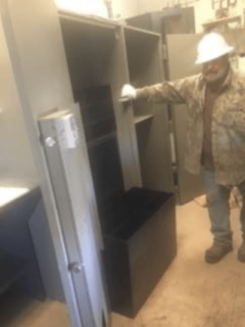 A man wearing a hard hat is standing in a room
