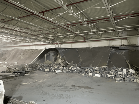 A large empty building with a lot of junk in it
