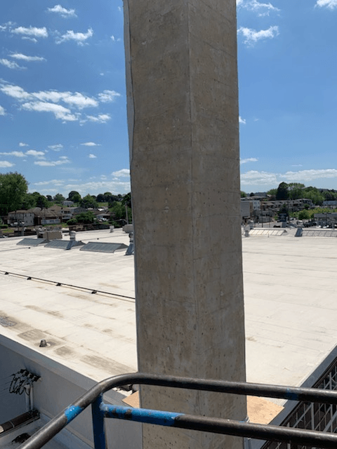 A view of the roof of a building from a balcony.