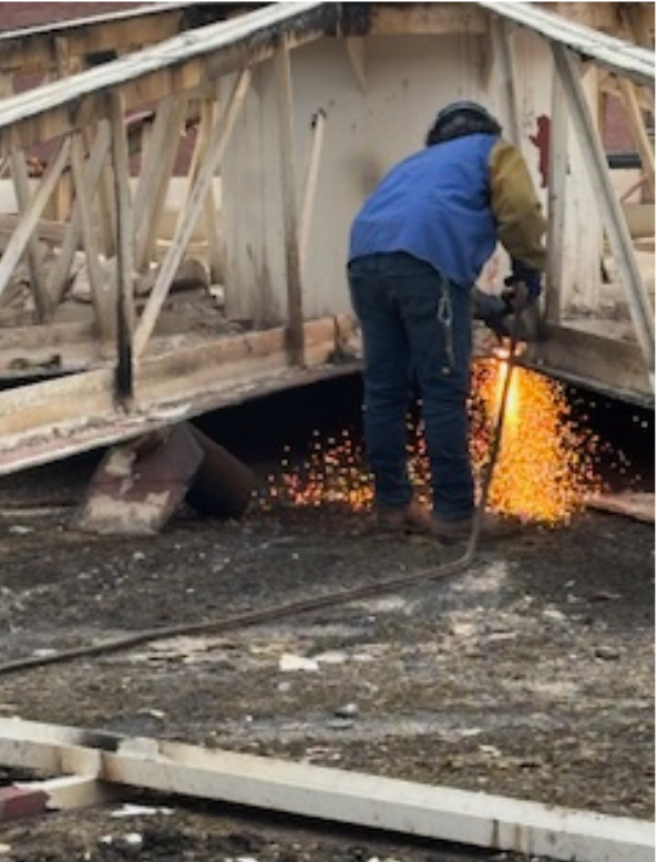 An Empire Services team member cuts up one of two digesters. 