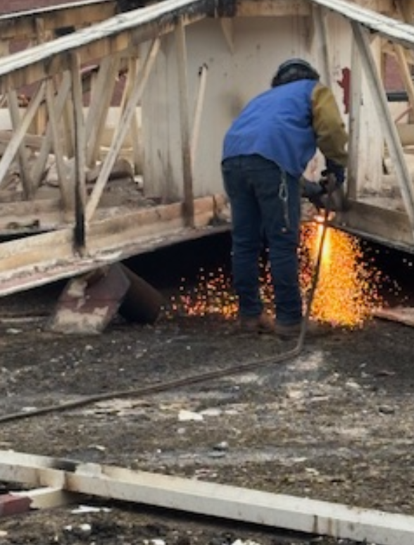 Empire Services team member torch cutting a digester.