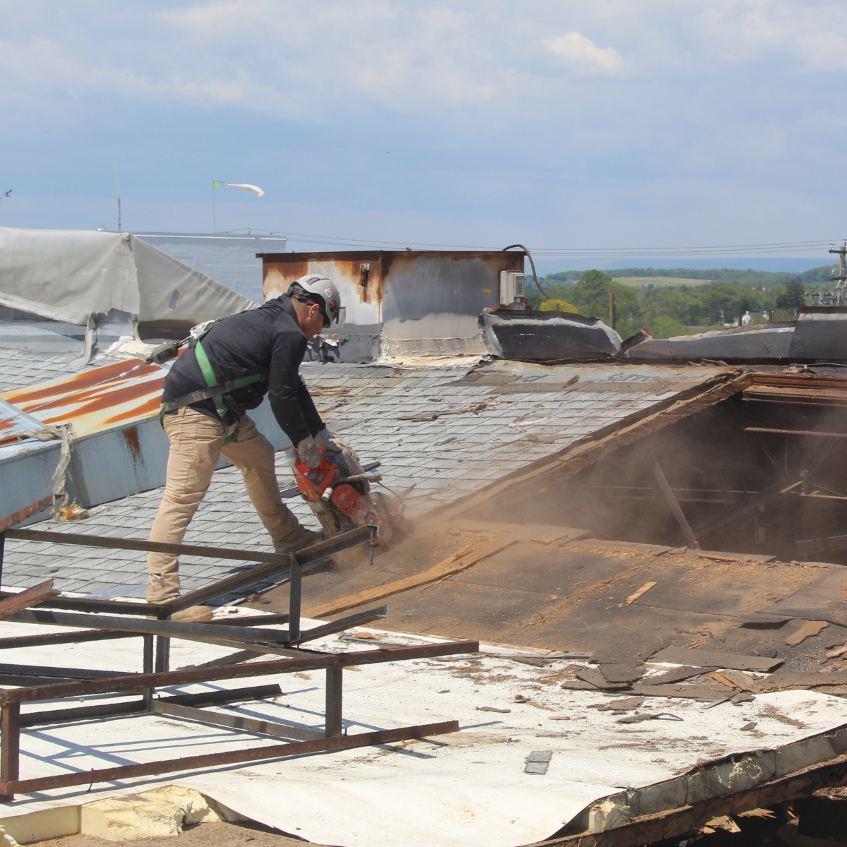 An Empire Services team member removes a section of roof.