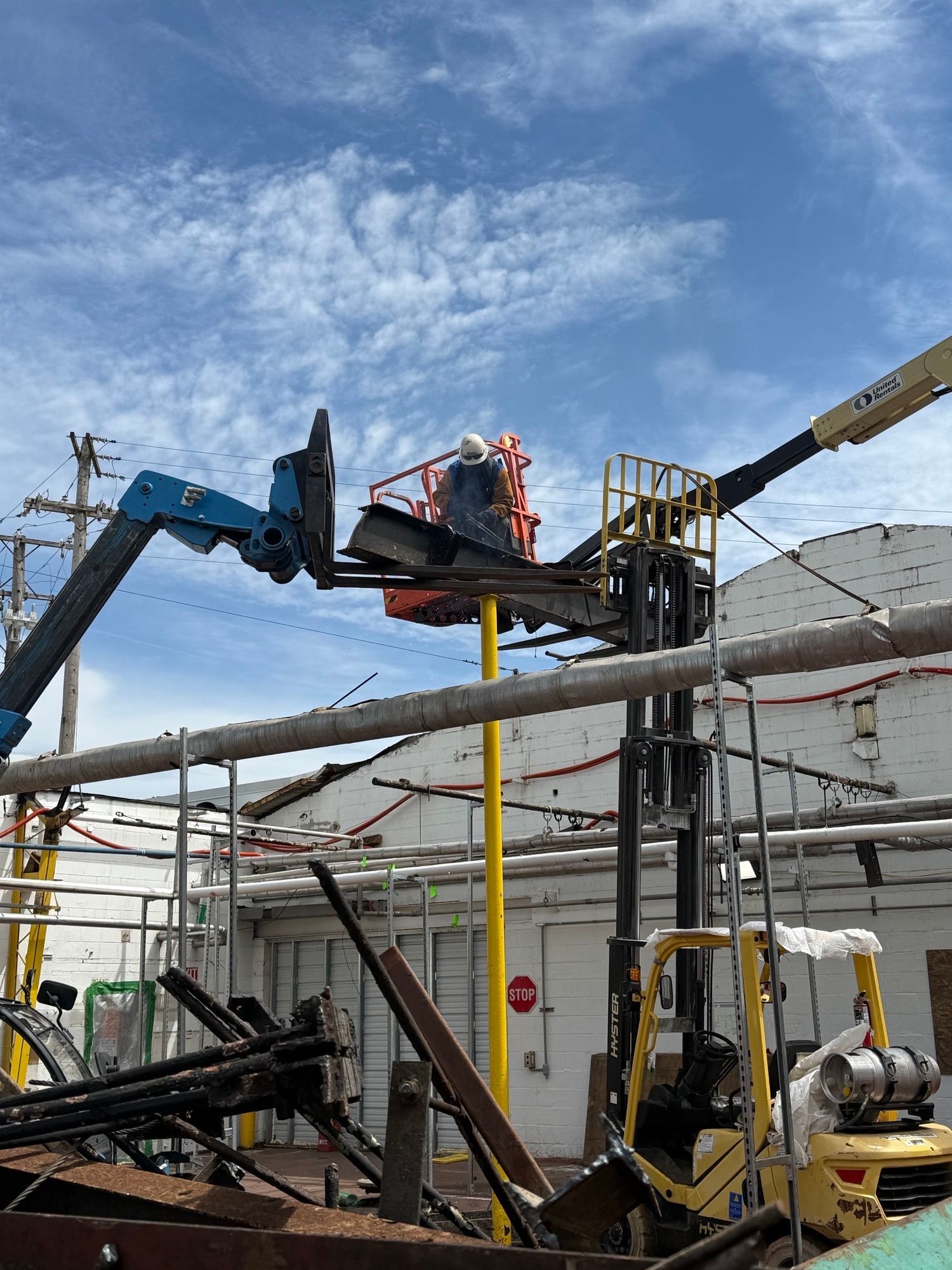 An Empire Services crew member torch cuts a support beam.
