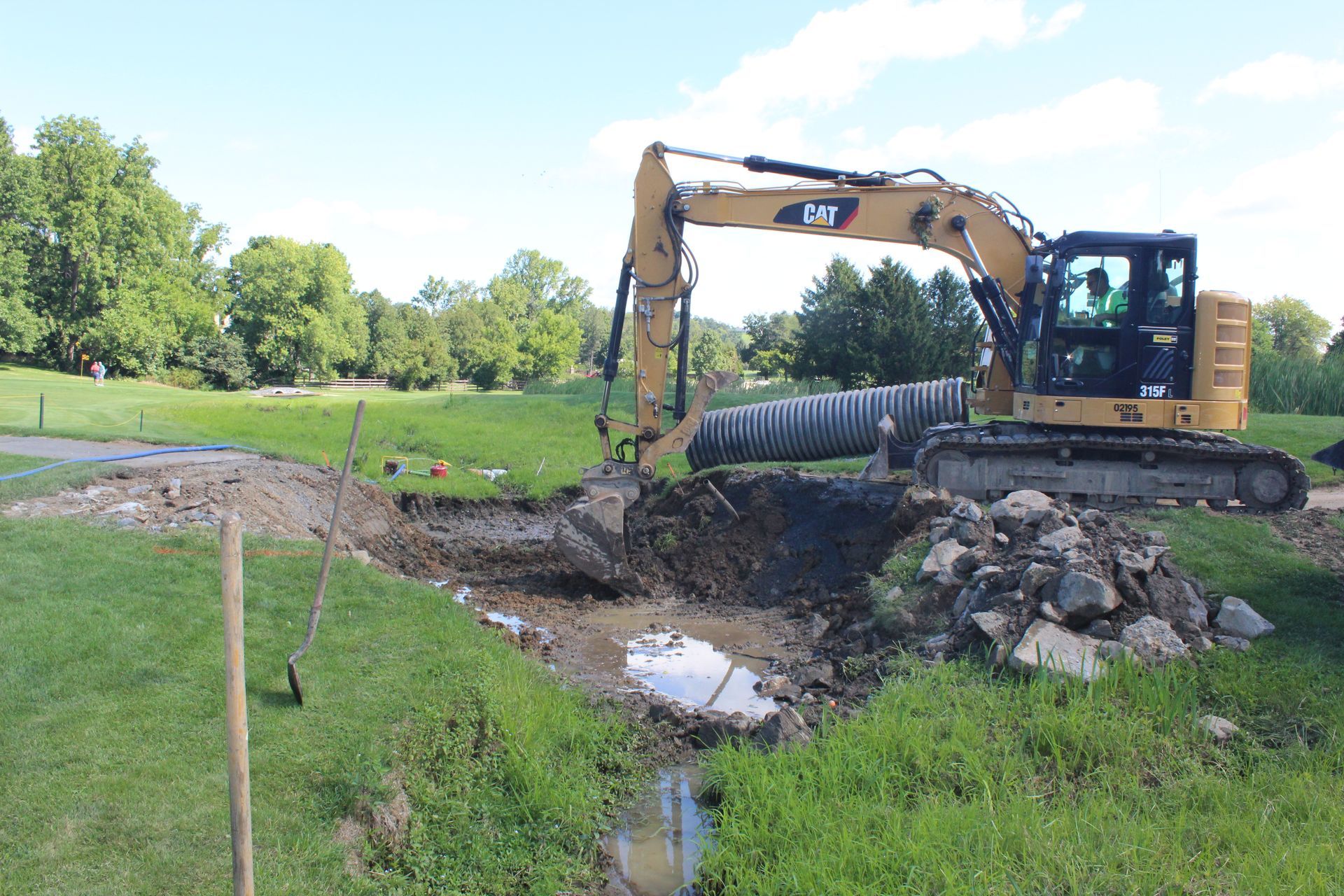 The team in action, excavating for the new concrete pipes.
