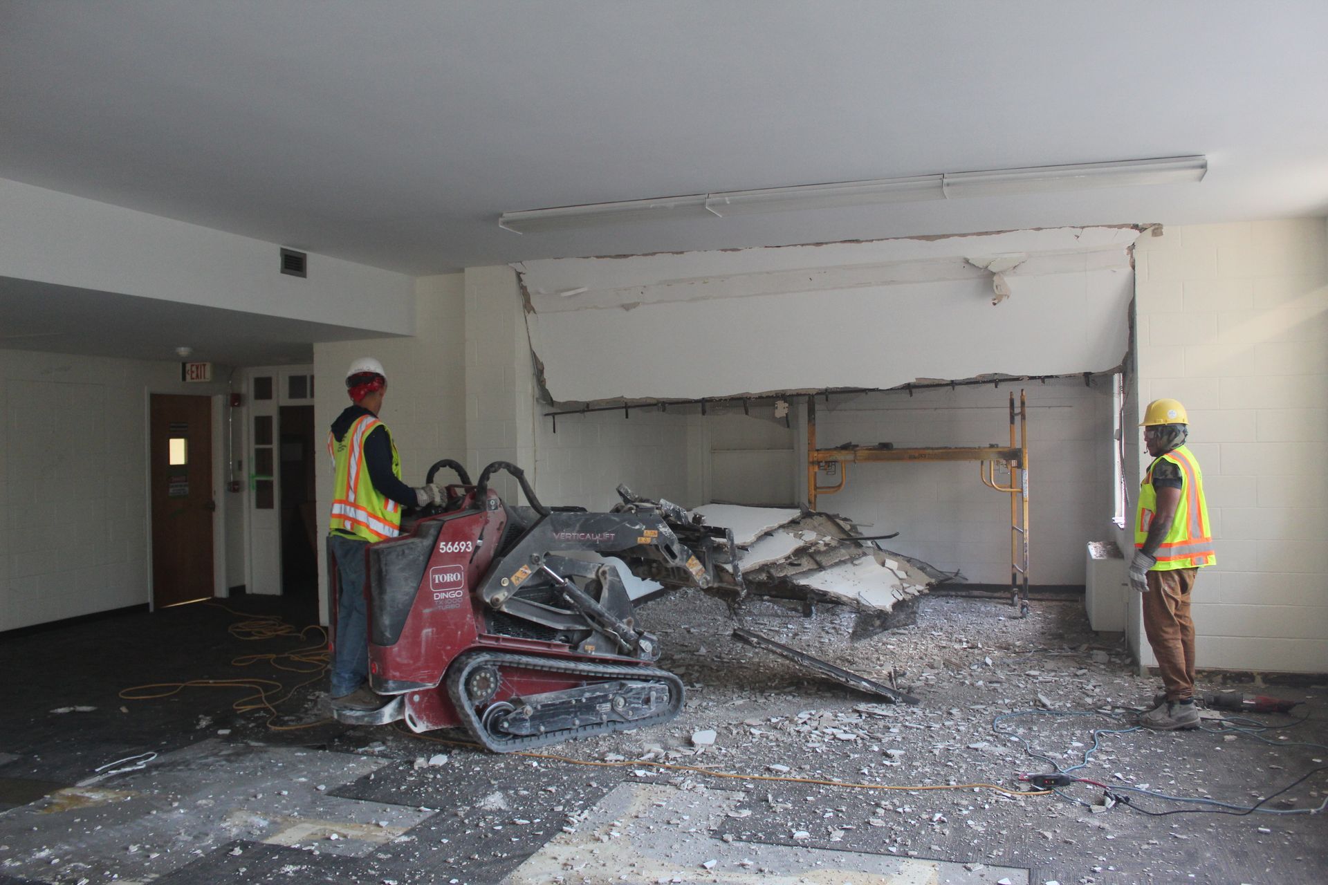 The Empire Services team demolishes a wall to create an open space.
