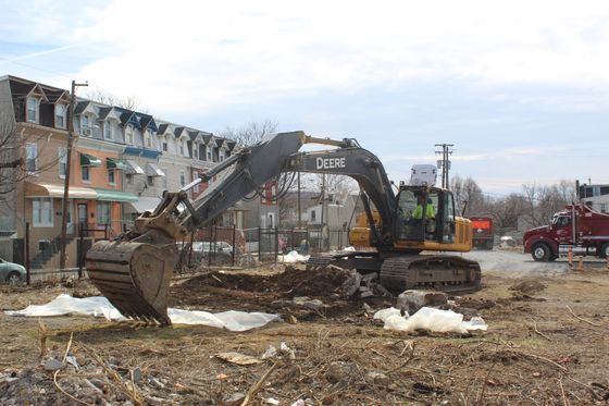 A large excavator is working on a construction site
