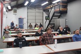 A group of people are sitting at tables in a room.
