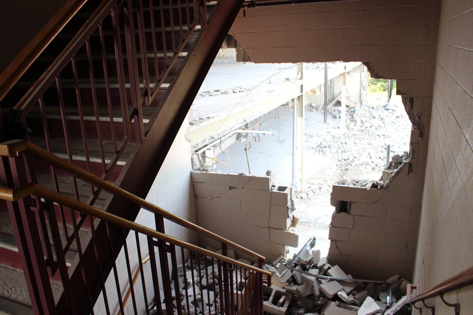 A staircase with a hole in the wall