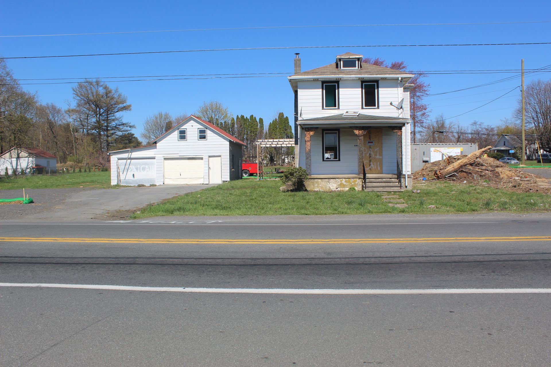 Shot of house and garage before demolition to make way for a new intersection.