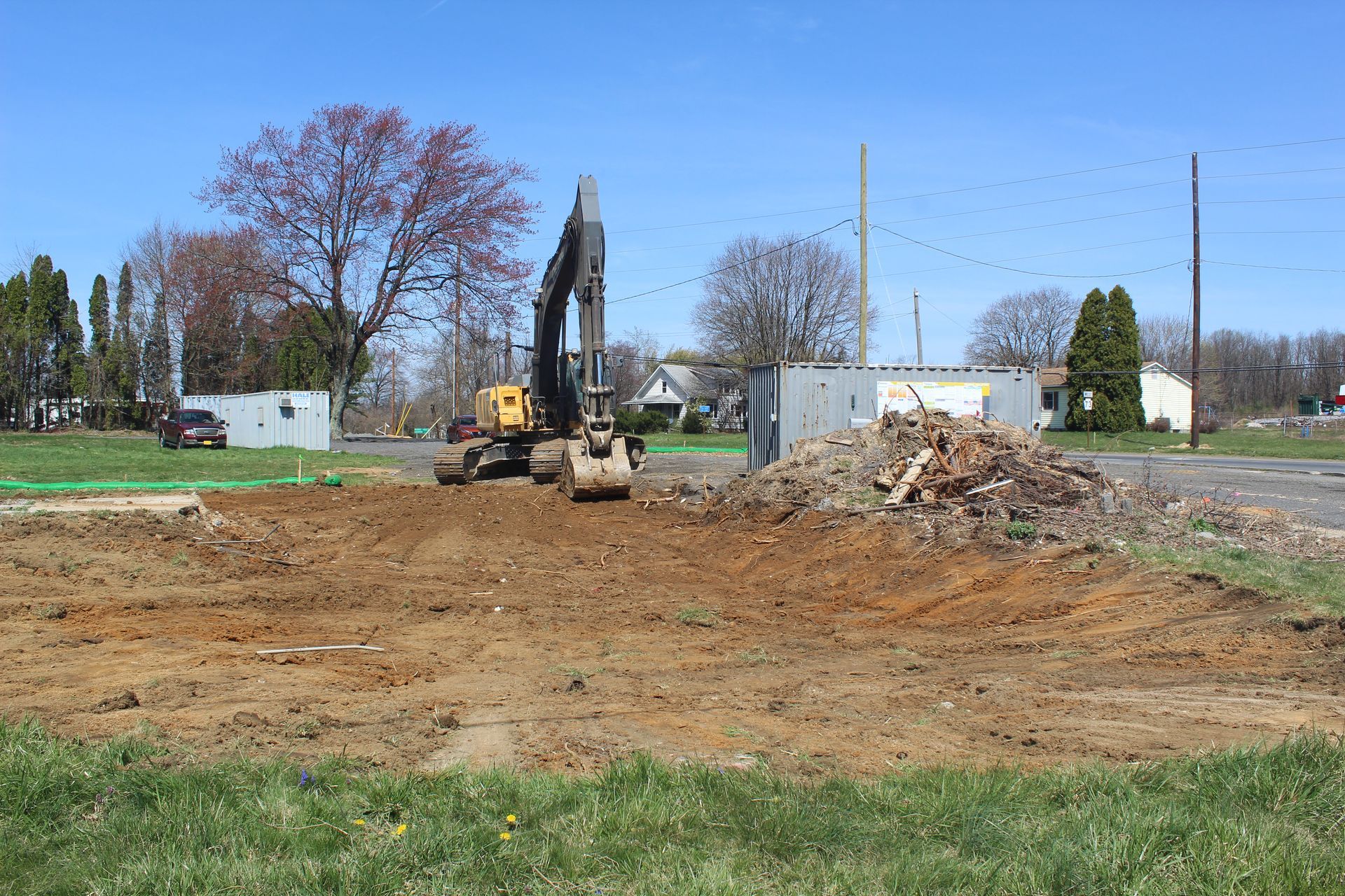 A large excavator is moving dirt in a field.