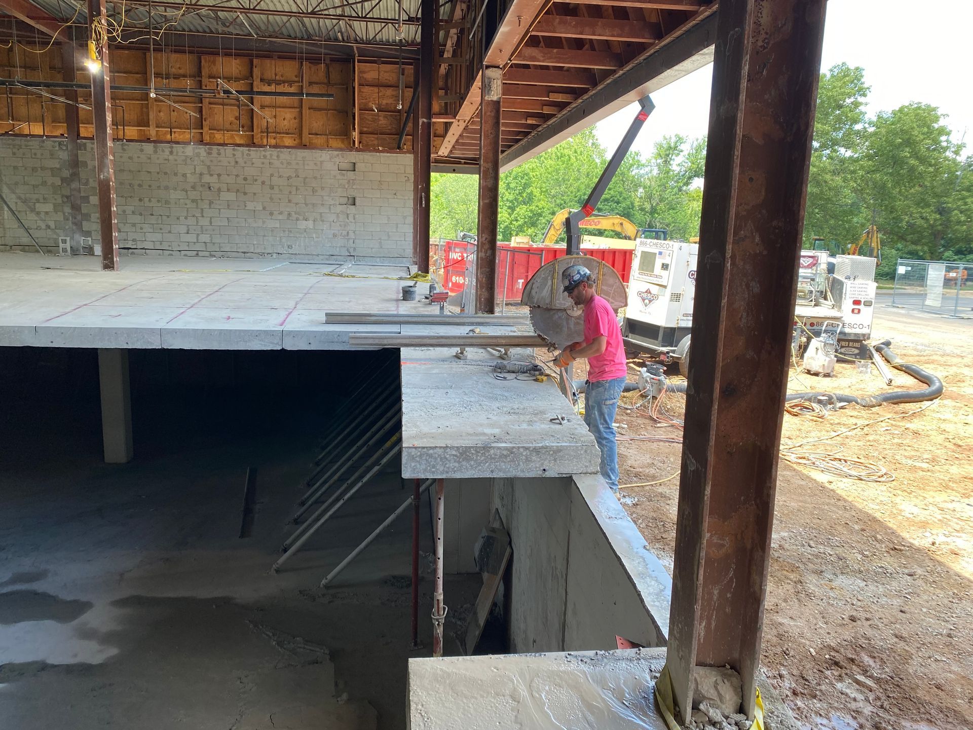 A man is cutting concrete in a building under construction.