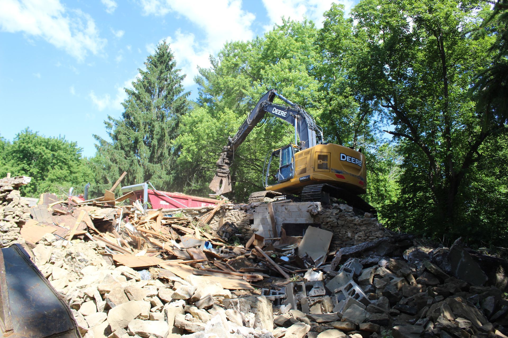 DVC dump truck receiving a load of debris from barn demolition.