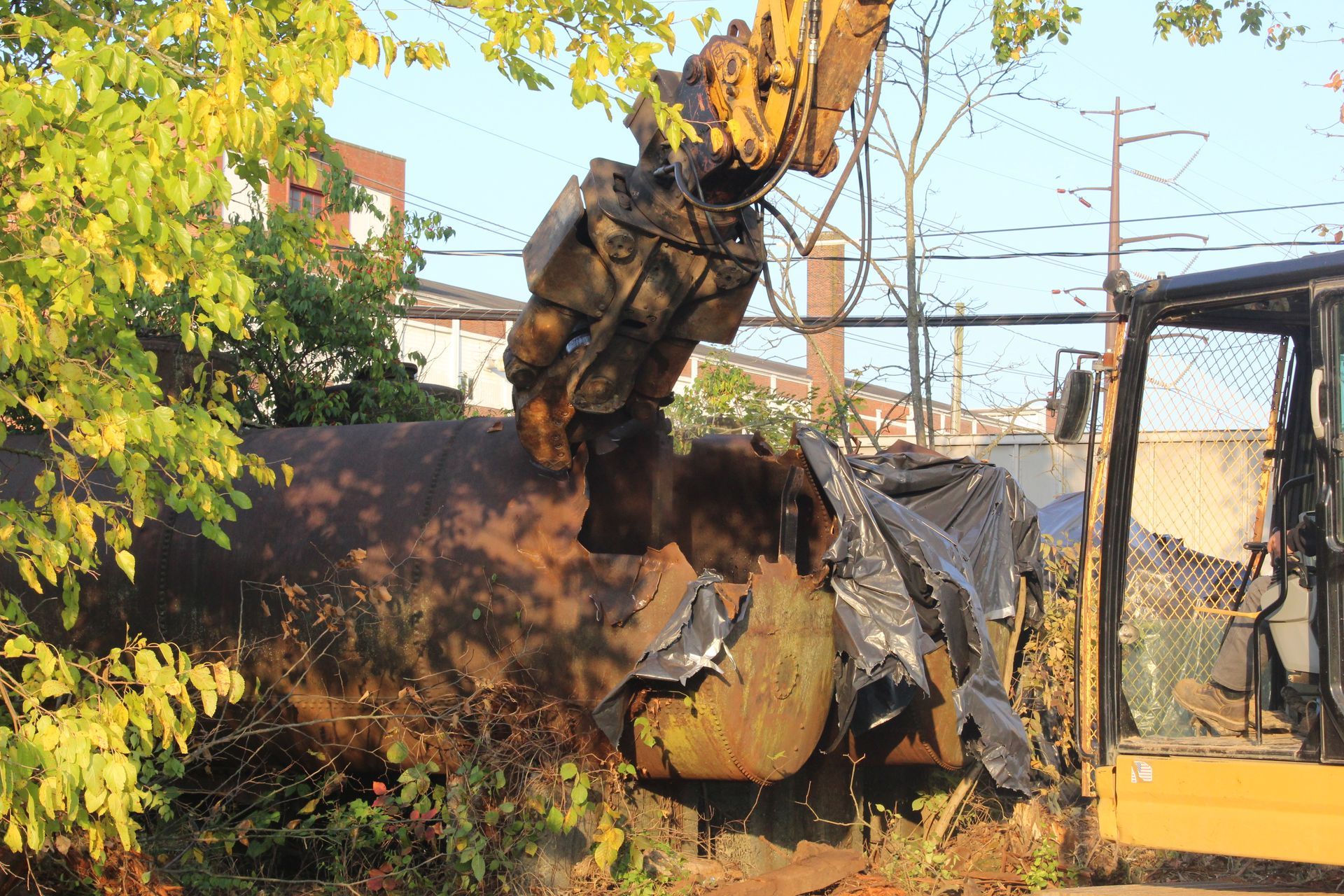 Opening storage tank to remove contents.