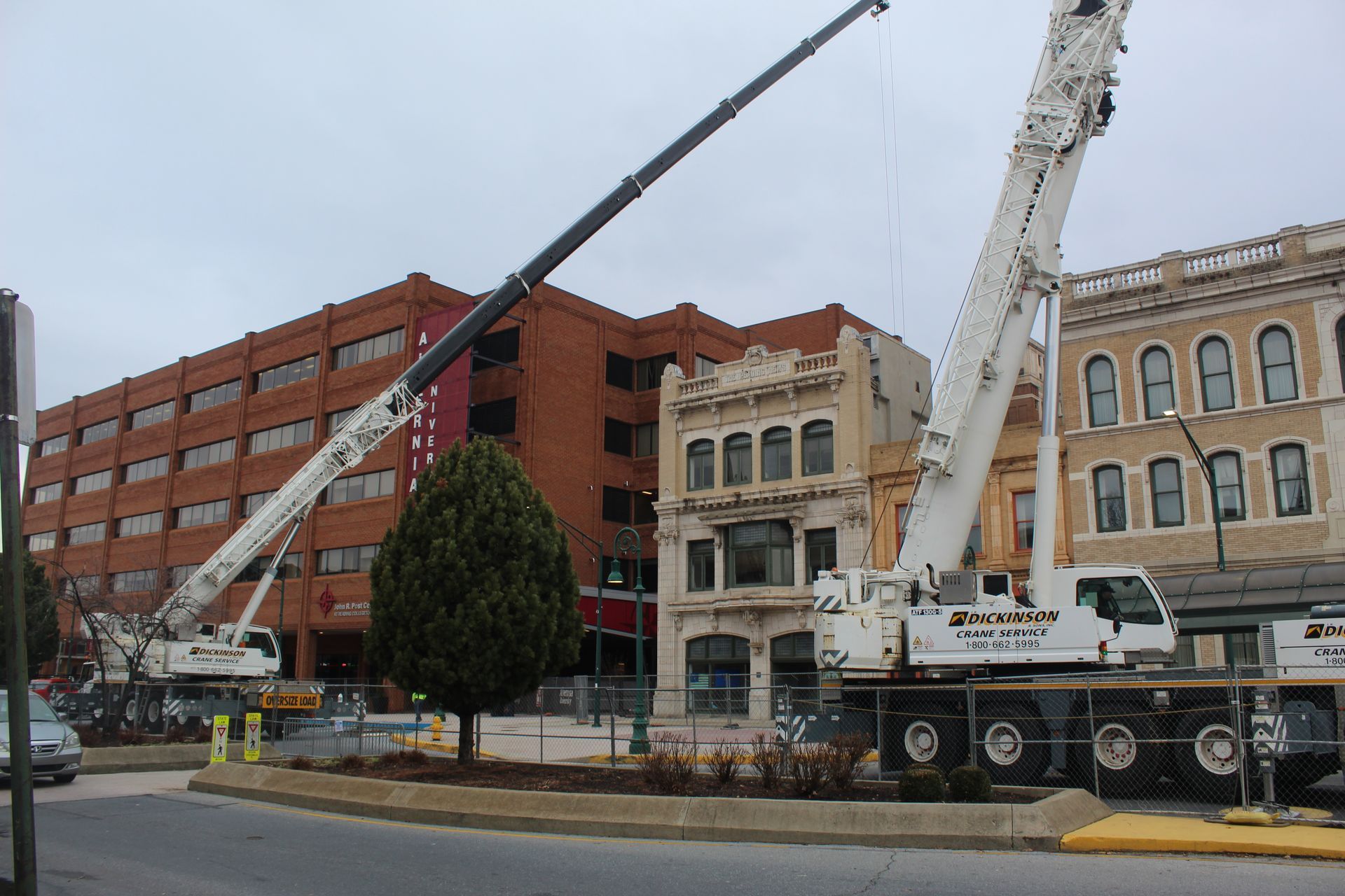 Using a crane to select demolish a roof on one of the structures on Penn Street. 