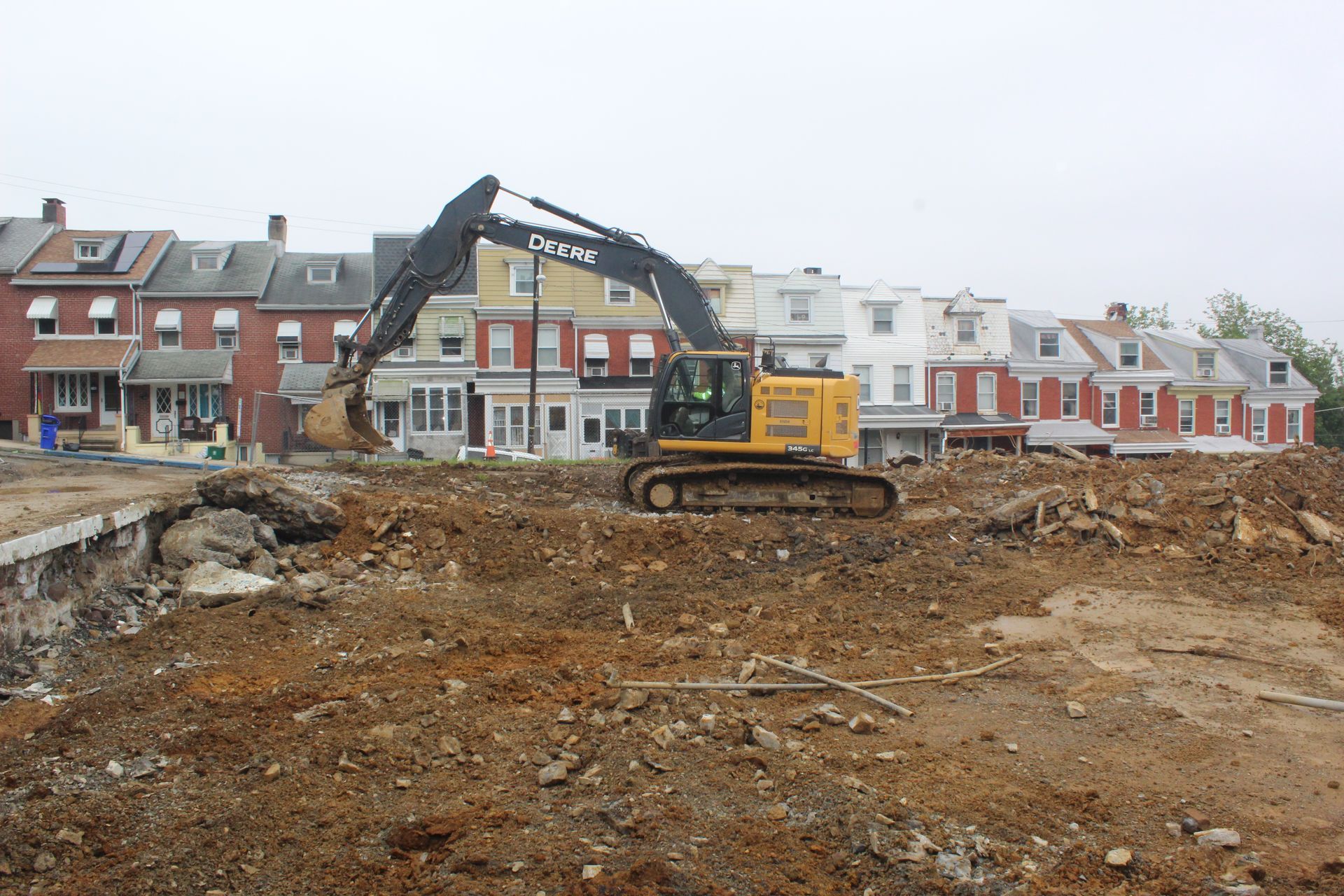 Using one of Empire Services' excavators to dig up the concrete.
