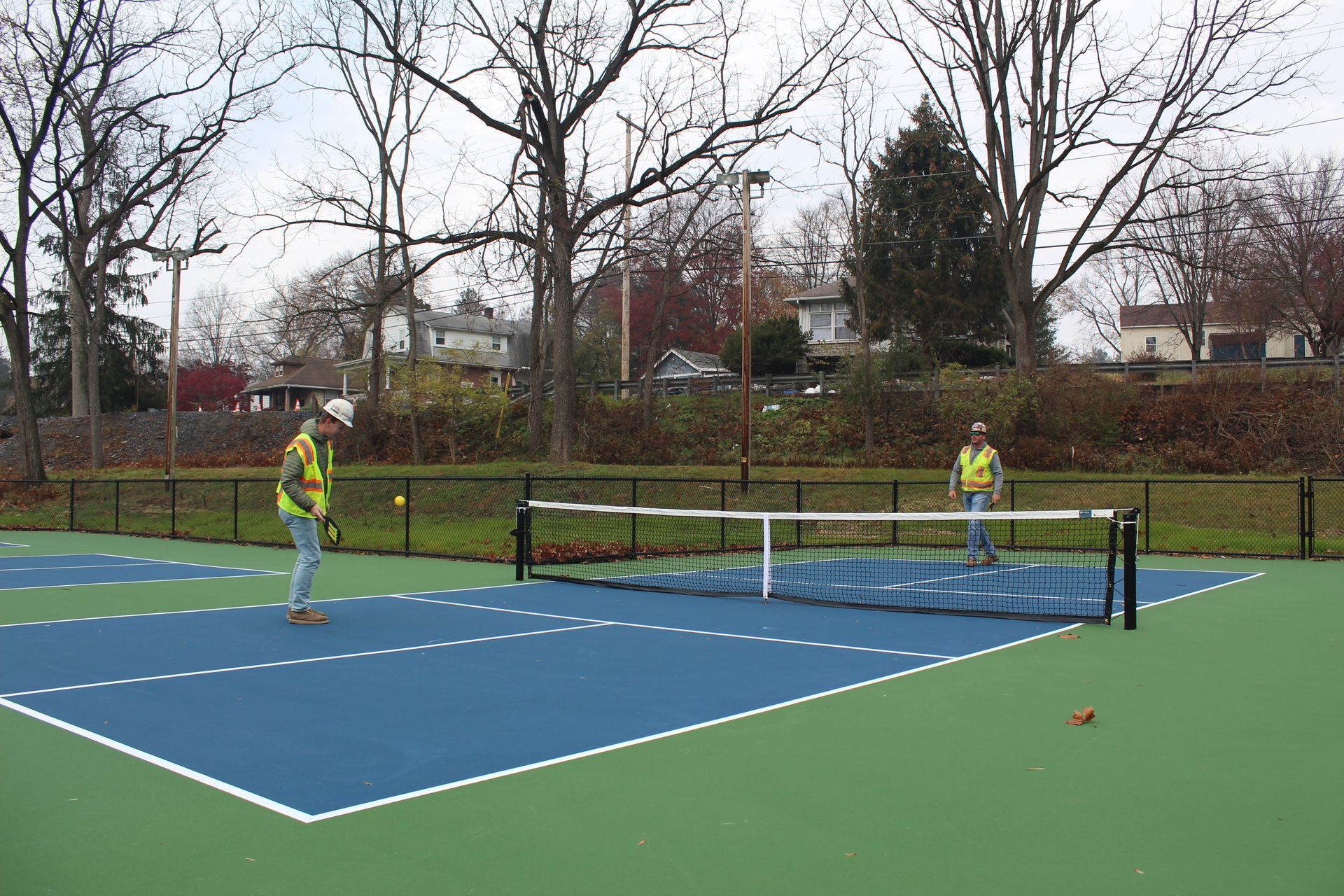 Empire Services team members try out the new pickleball blue and green court. 