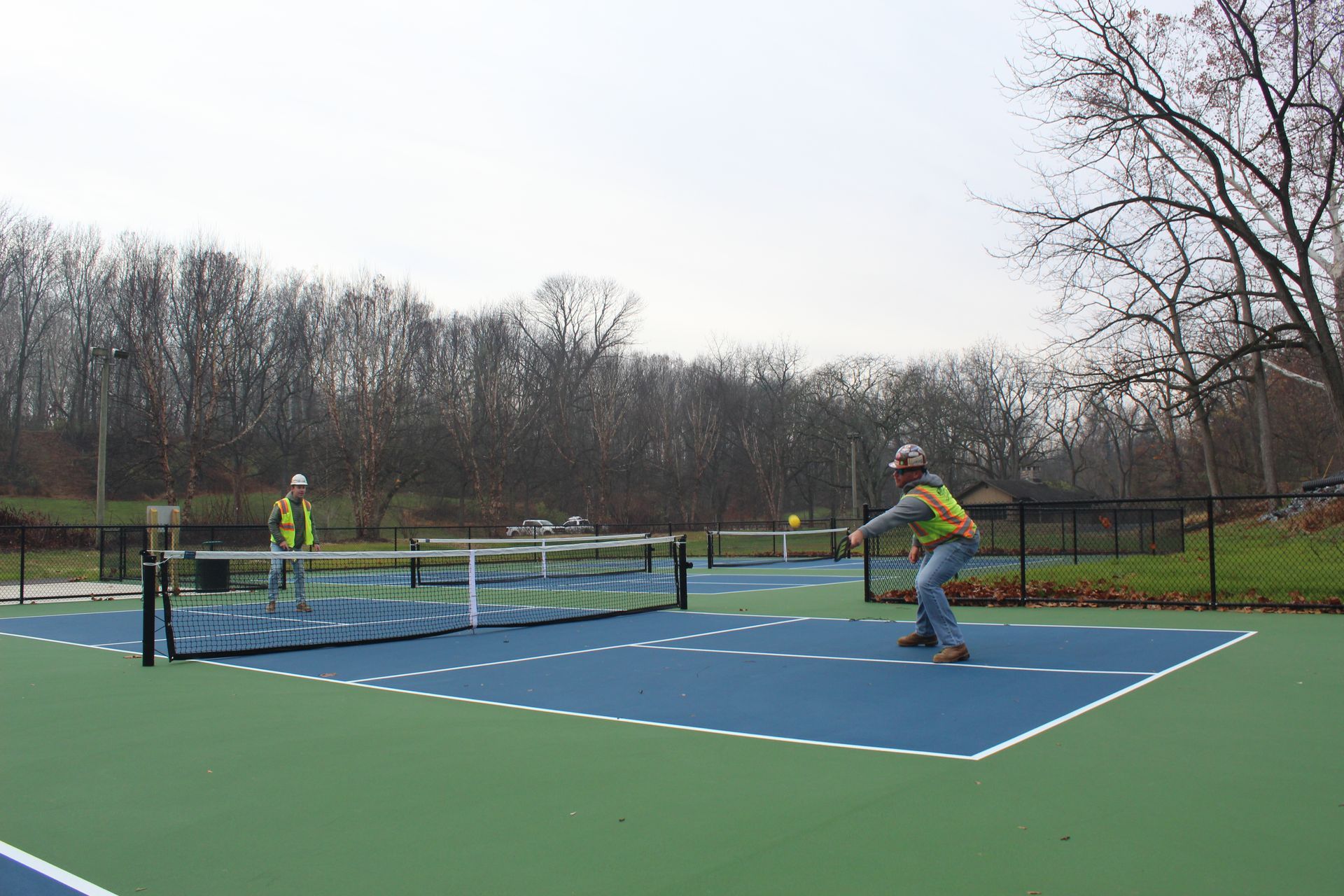 Gavin O'Neill and Ryan George playing pickleball on new blue and green court.