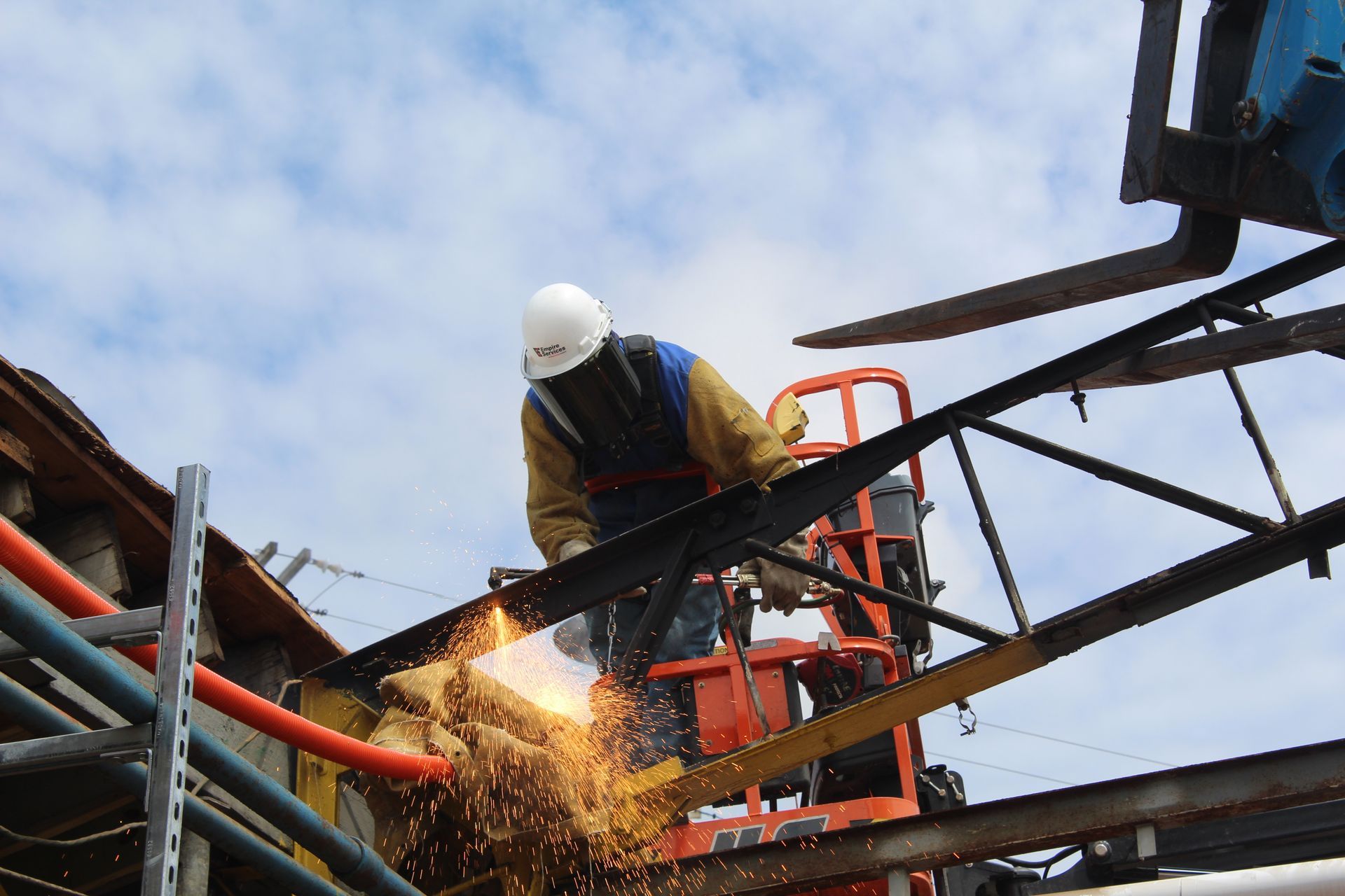An Empire Services crew member torch cuts a roof support.