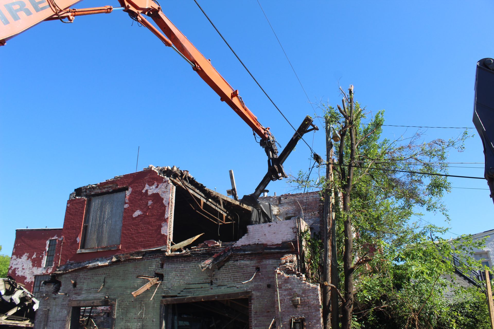 Our expert excavator operator skillfully removes debris without touching utility lines. 