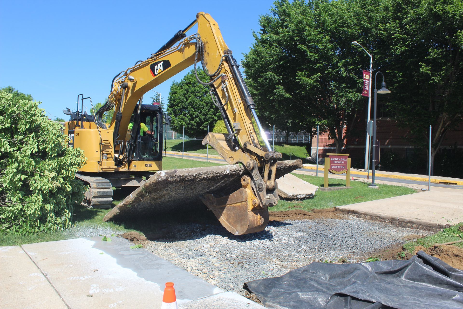 Removing part of a sidewalk for the new construction entrance.