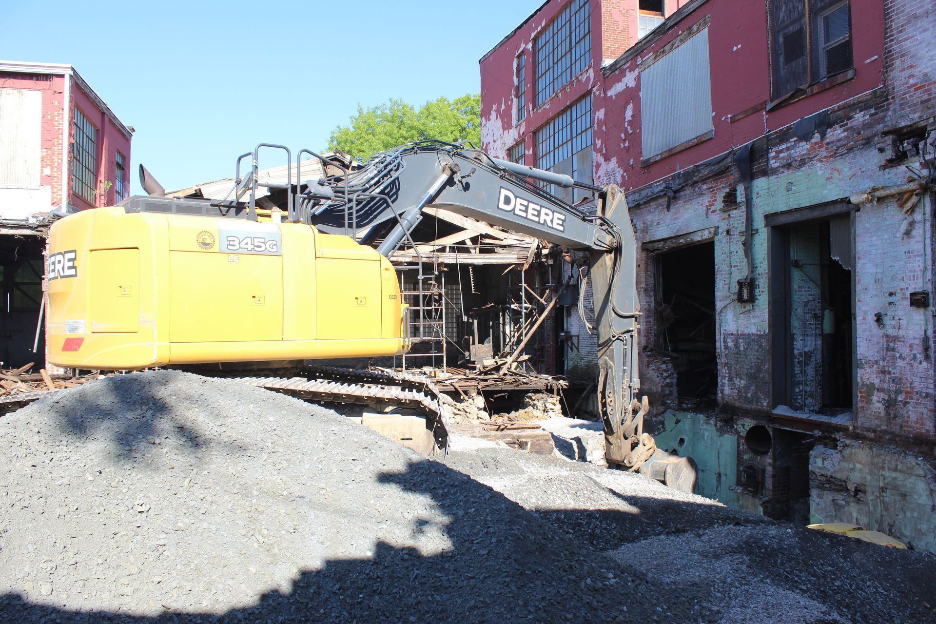 Stone backfill materials are delivered to the open work area for compaction.