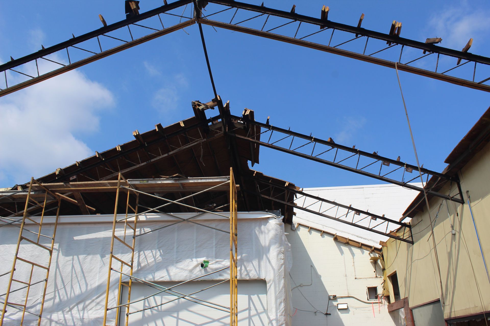 Removing the wood roof on the other side of the building.