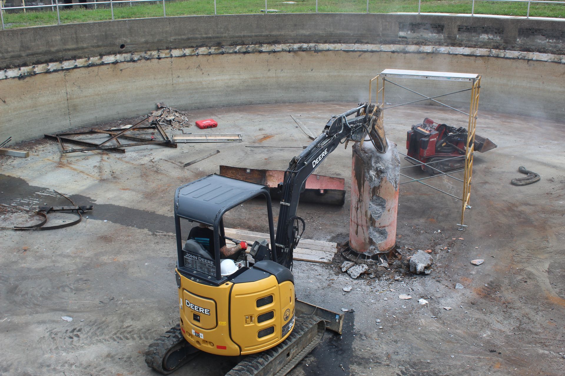 Hammering down the concrete center column in the clarifier.