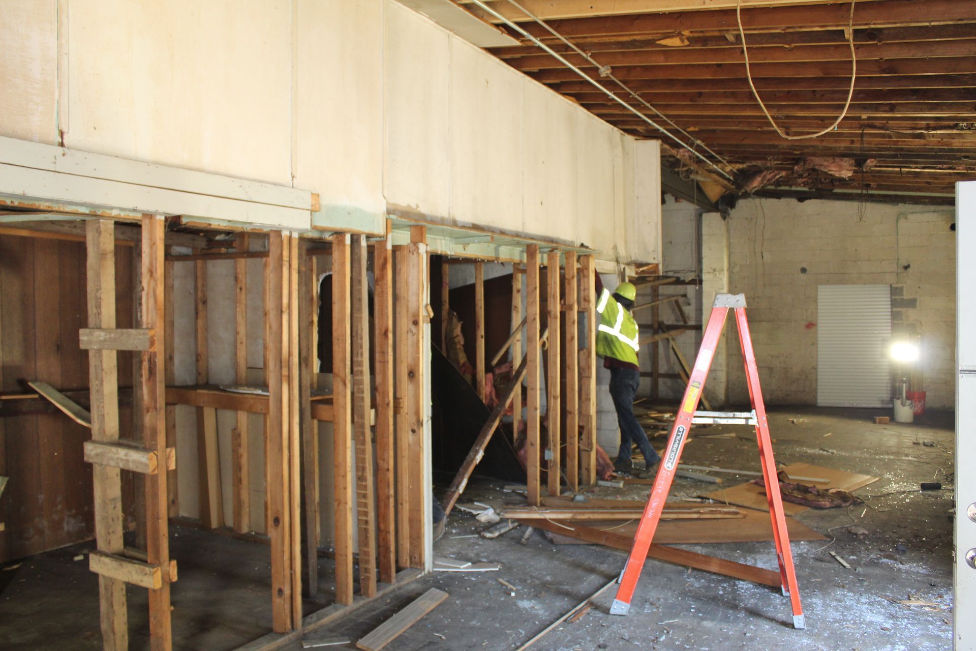 Empire Services crew removes walls, shelving, and ceilings.