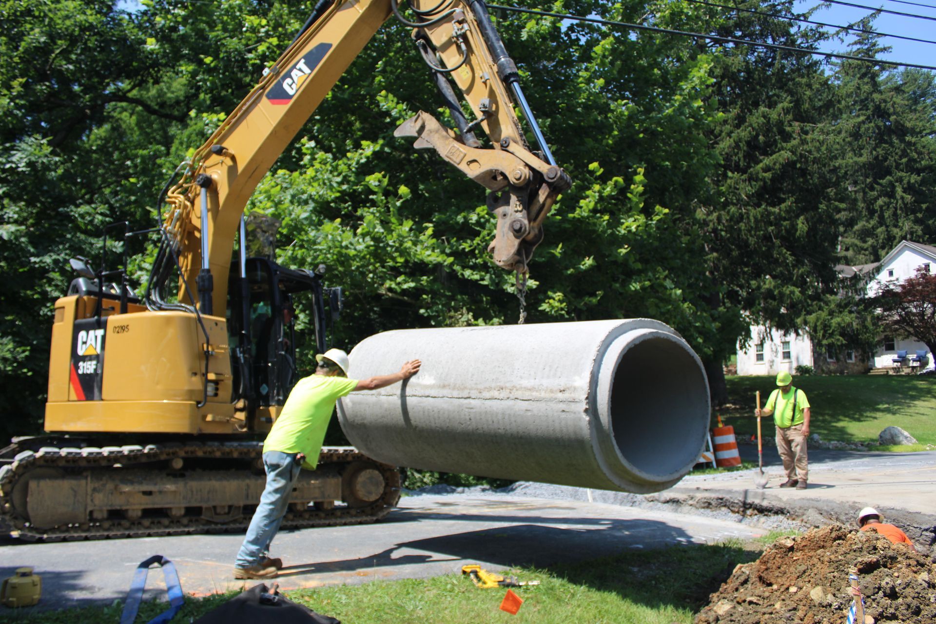 Guiding the concrete pipe into place.