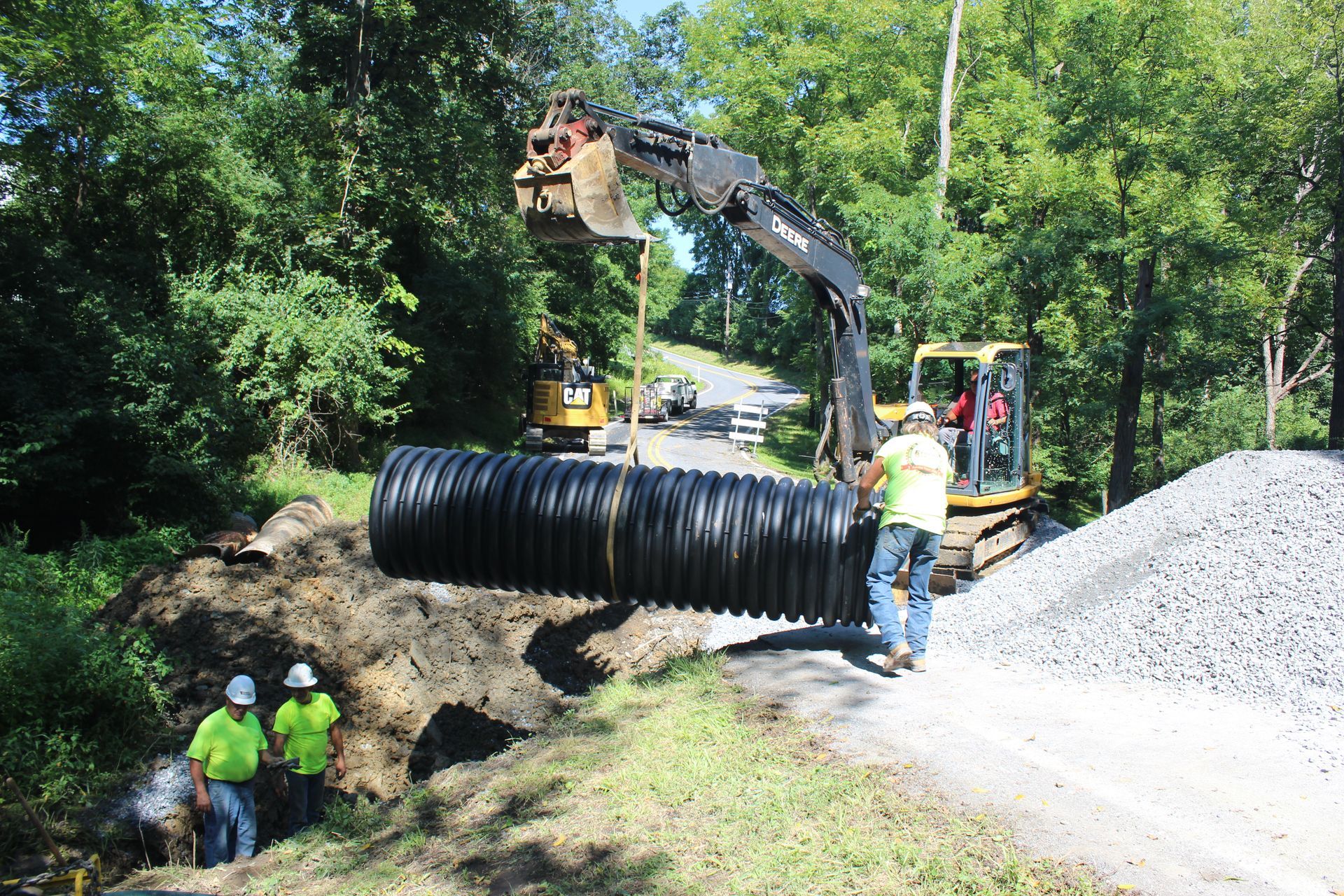 The Empire Services team positions the plastic piping.