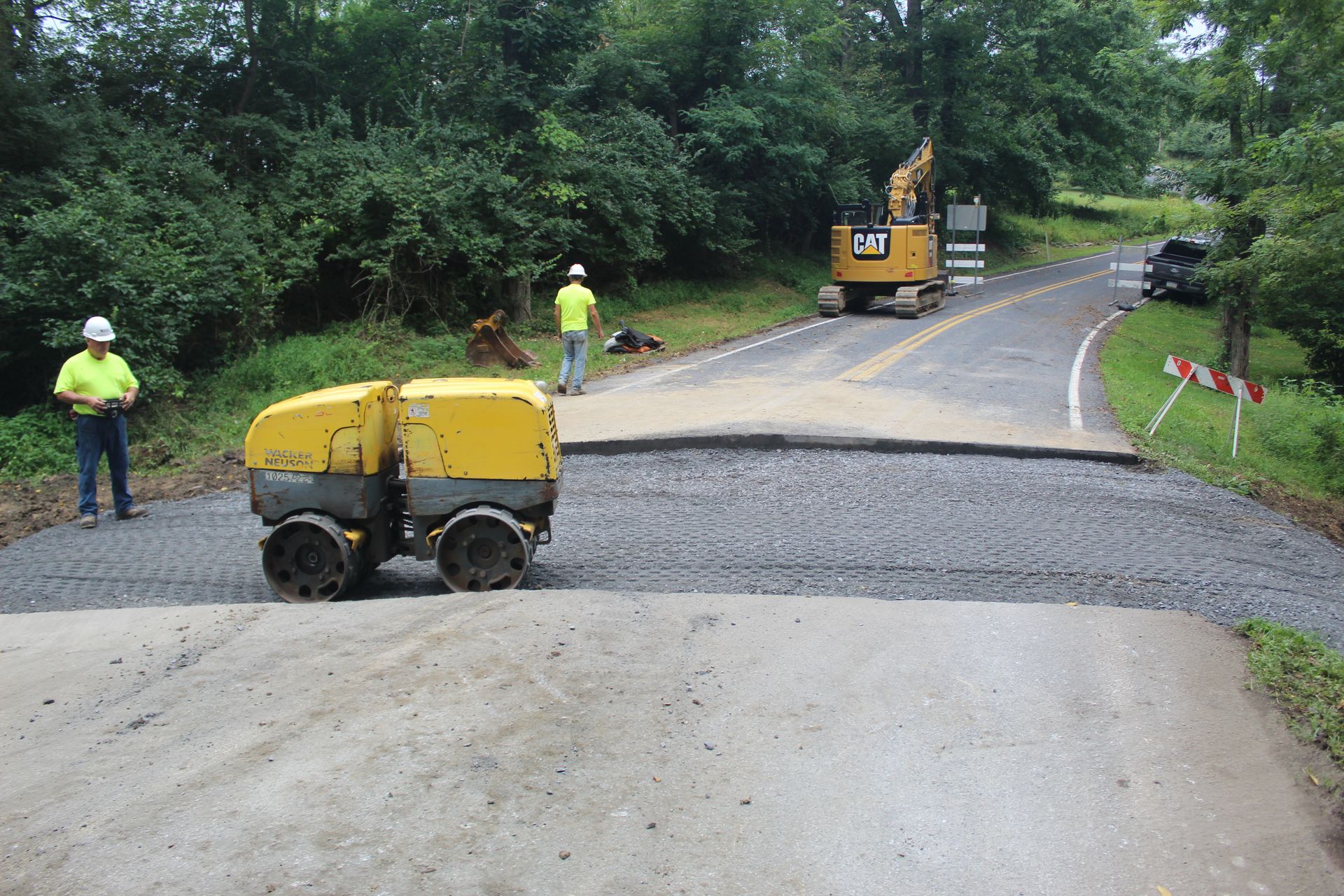 Compacting the culvert in preparation for the final phase of the project. 