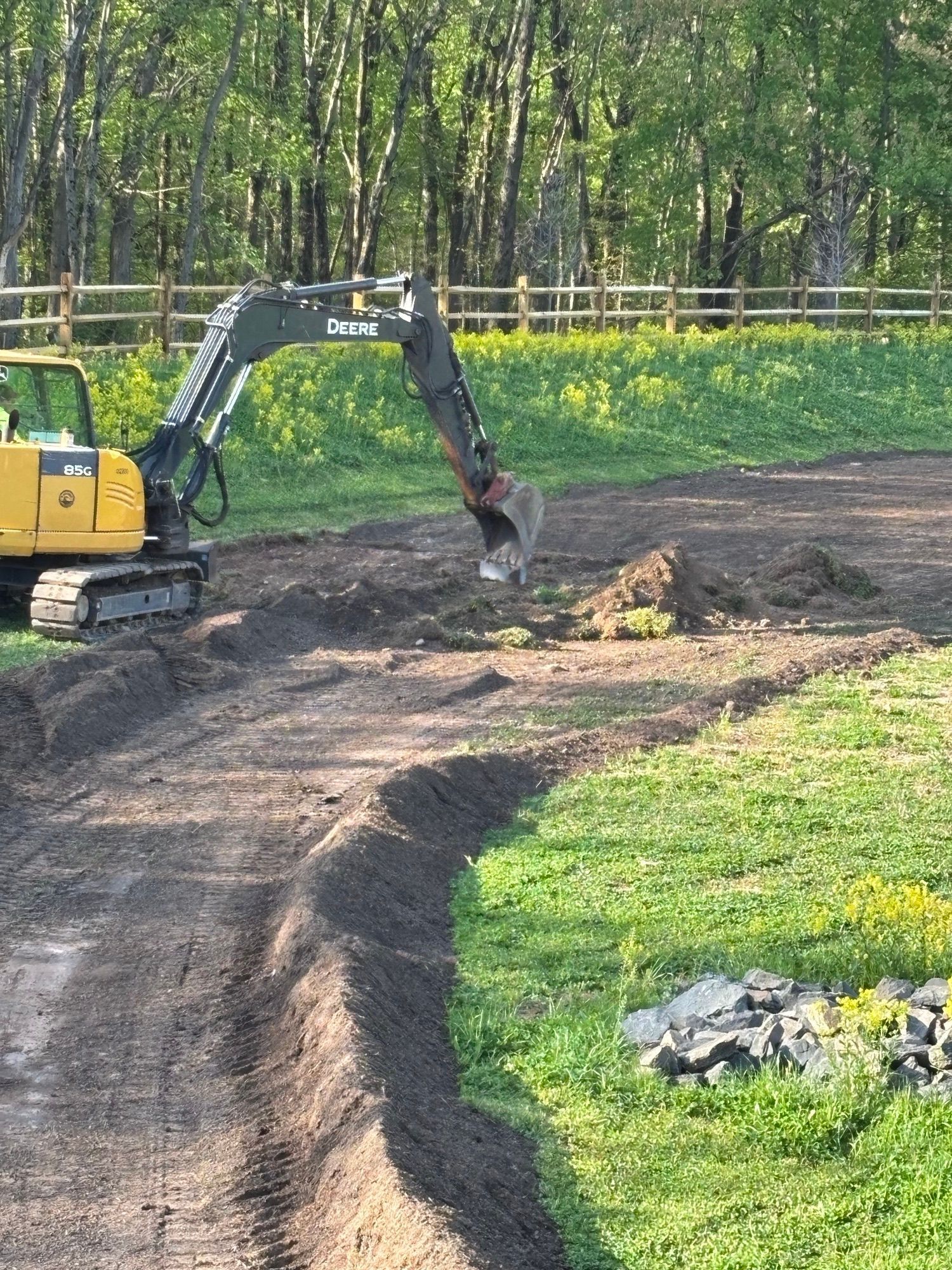 Empire Services uses a small excavator to dig up the basin for piping.