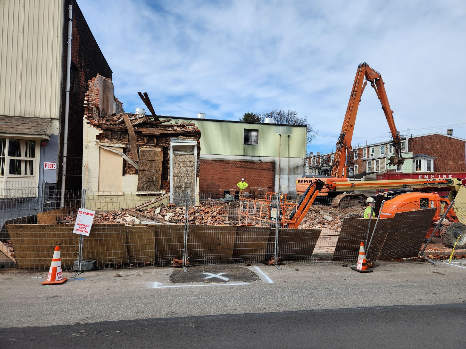 A building is being demolished on the side of the road