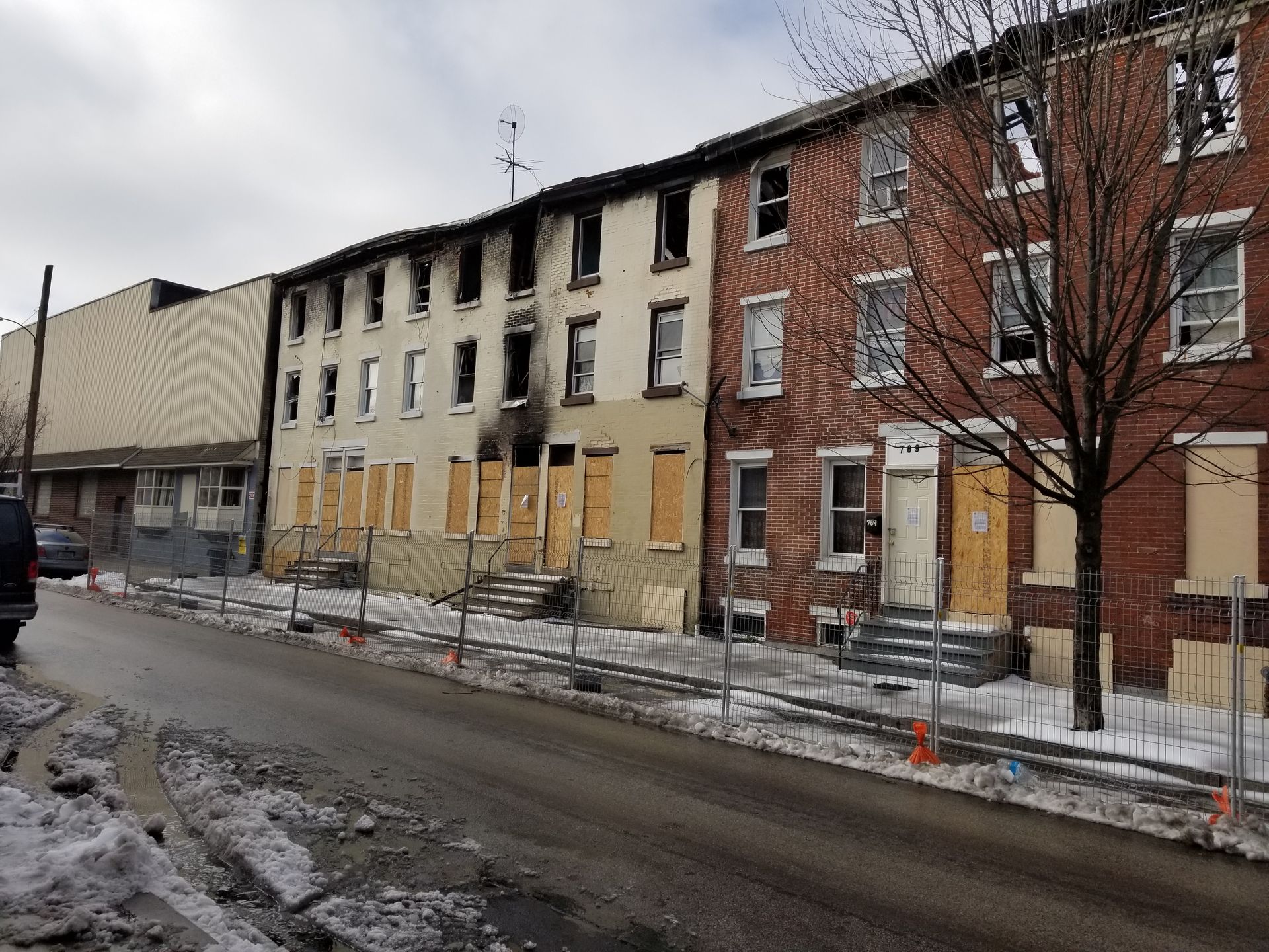 A row of brick buildings with smoke coming out of the windows
