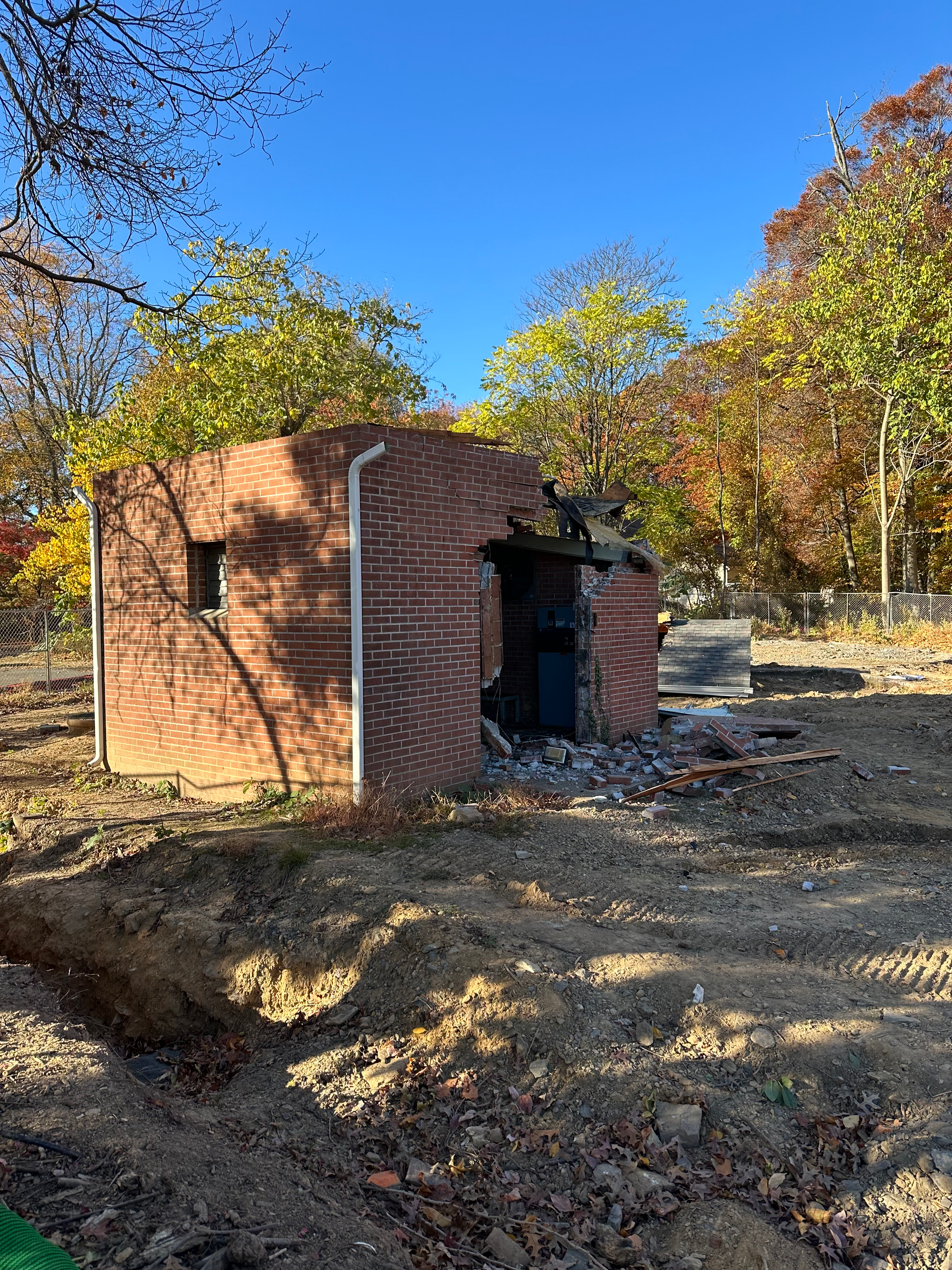 Demolition of booster pump house next above ground water tank.