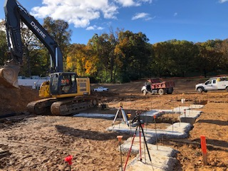 A large excavator is moving dirt on a construction site.